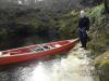 Guy Bryant by the canoe with cave entry to his right - SantaFeSandy