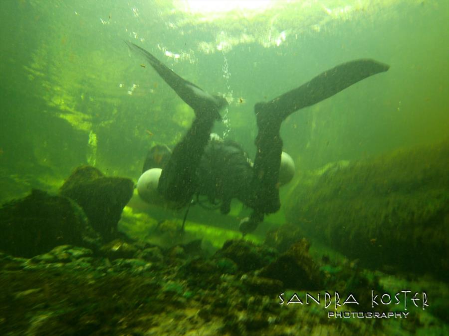 Lineater Spring - Guy exiting the cave system back to the canoe