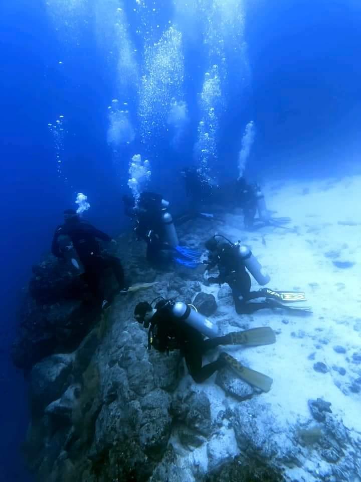 Divers on wall edge