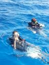 Chris and Conner getting ready to dive the Kittiwake in Grand Cayman