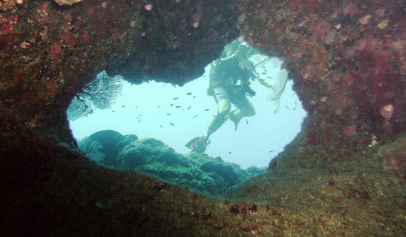 NE Tokashiki - Divers beyond opening in coral formation