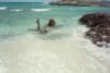 Water Cay - Small beach and remains of Cuban fishing skiff