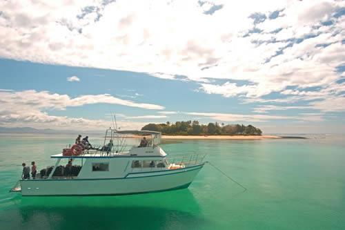 Beqa Lagoon Resort - Boat on crystal clear water