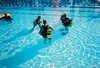 Sue with students in the pool