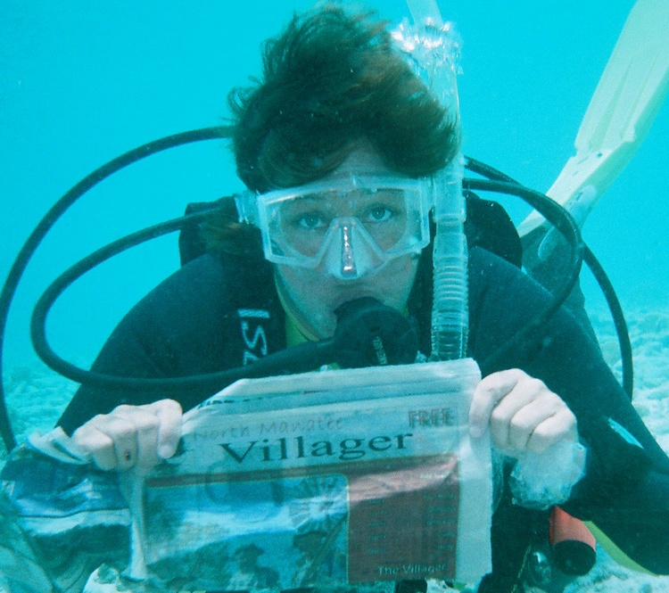 Sue reading the local paper underwater in Bonaire.