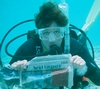 Sue reading the local paper underwater in Bonaire.