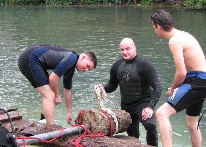 Greg and others lifting a pole out of the river during during TrashFest 2009