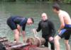 Greg and others lifting a pole out of the river during during TrashFest 2009