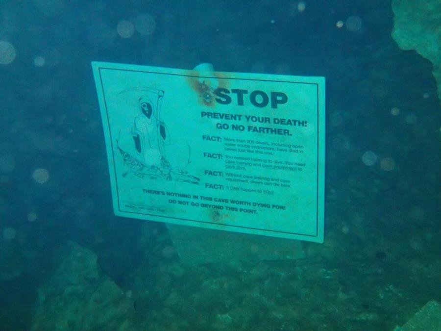 Sign in front of an underwater cave in Devil’s Den