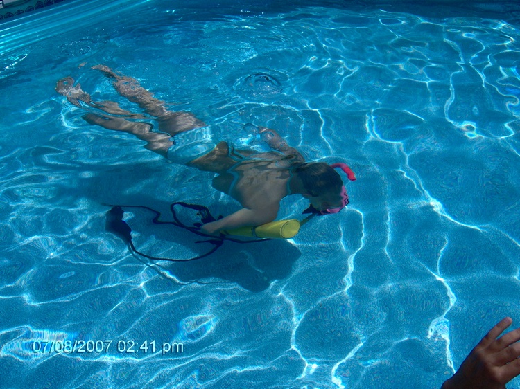 My daughter in pool with pony