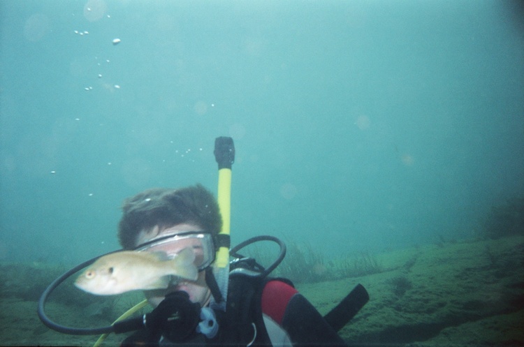 Taylor with a fish swimming by