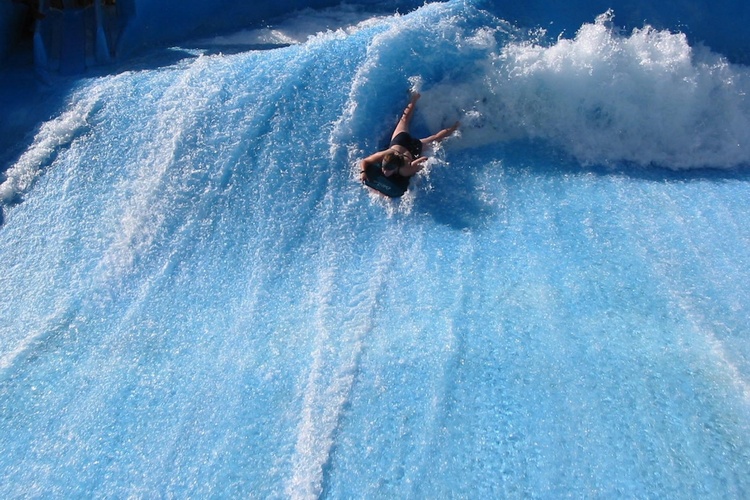 Daughter surfing at water park Wild Wadi Dubai UAE