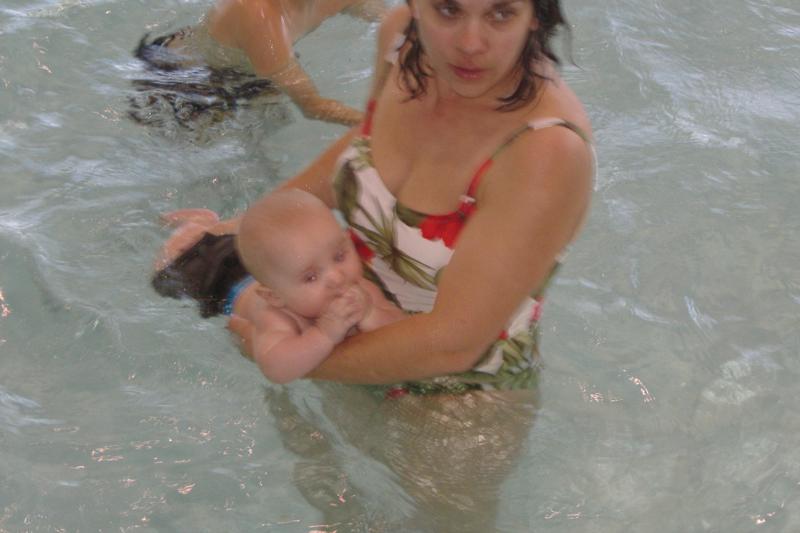 wife taking son for his first swim 9 months old