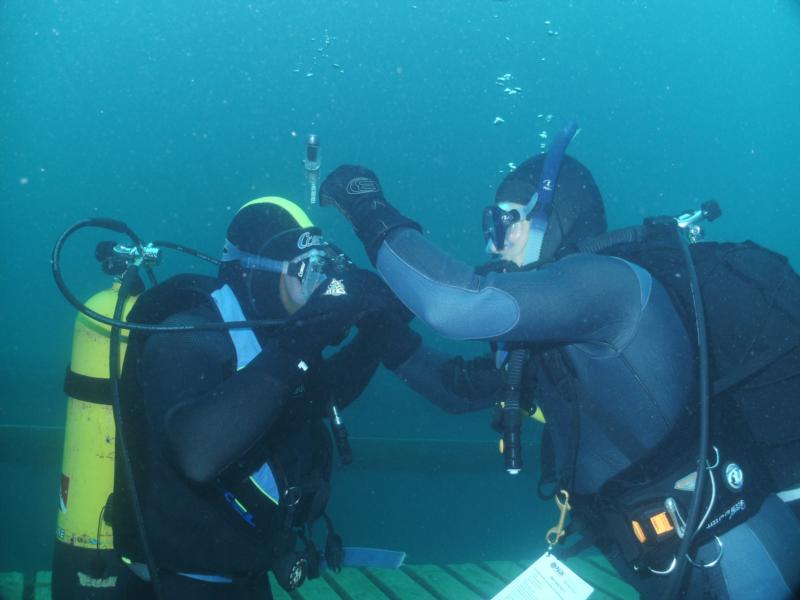 Gypsydiver giving student a hand