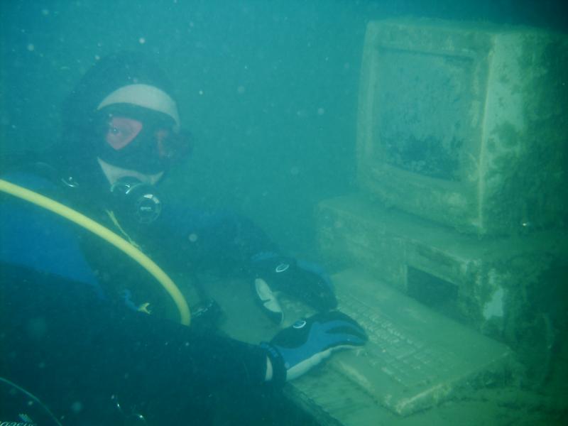 scuba diver in water with computer